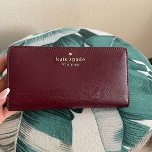 Kate Spade burgundy spencer slim bifold wallet.